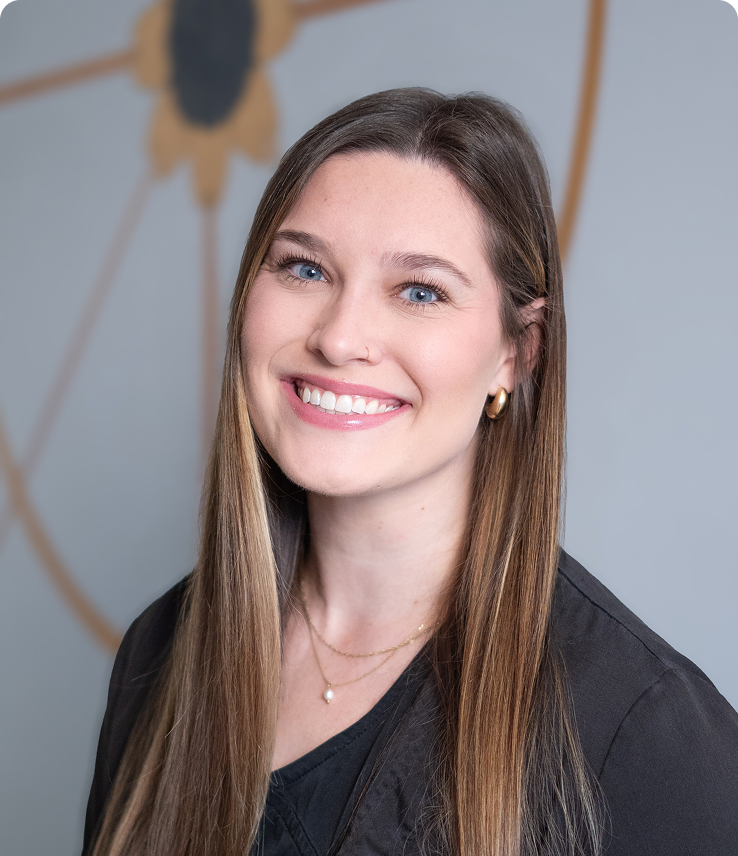 Smiling Jenna Wesselman, RDH at Solstice Dental in Louisville, KY with necklace and earrings