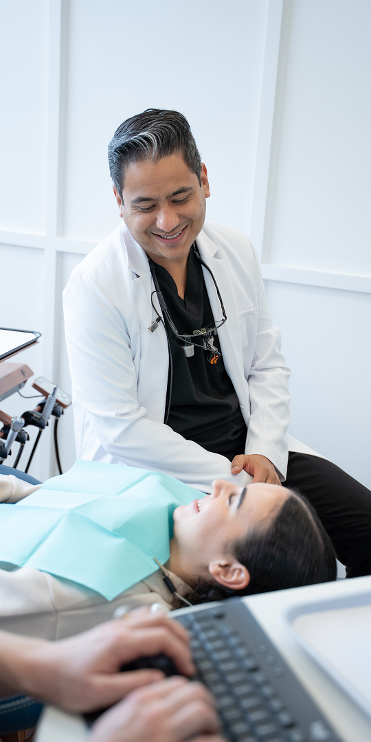 Dentist smiling at patient during appointment at Solstice Dental in Louisville, KY