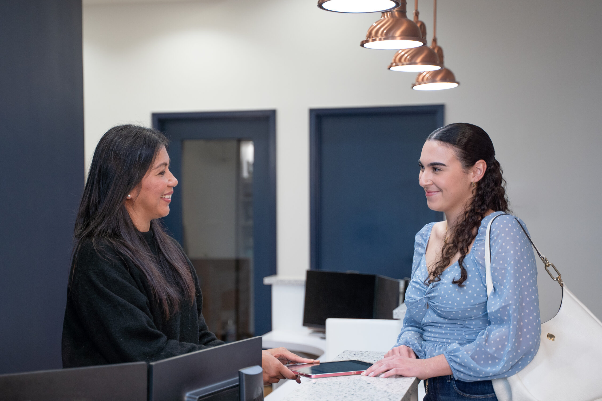 Receptionist greeting patient at Solstice Dental in Louisville, KY